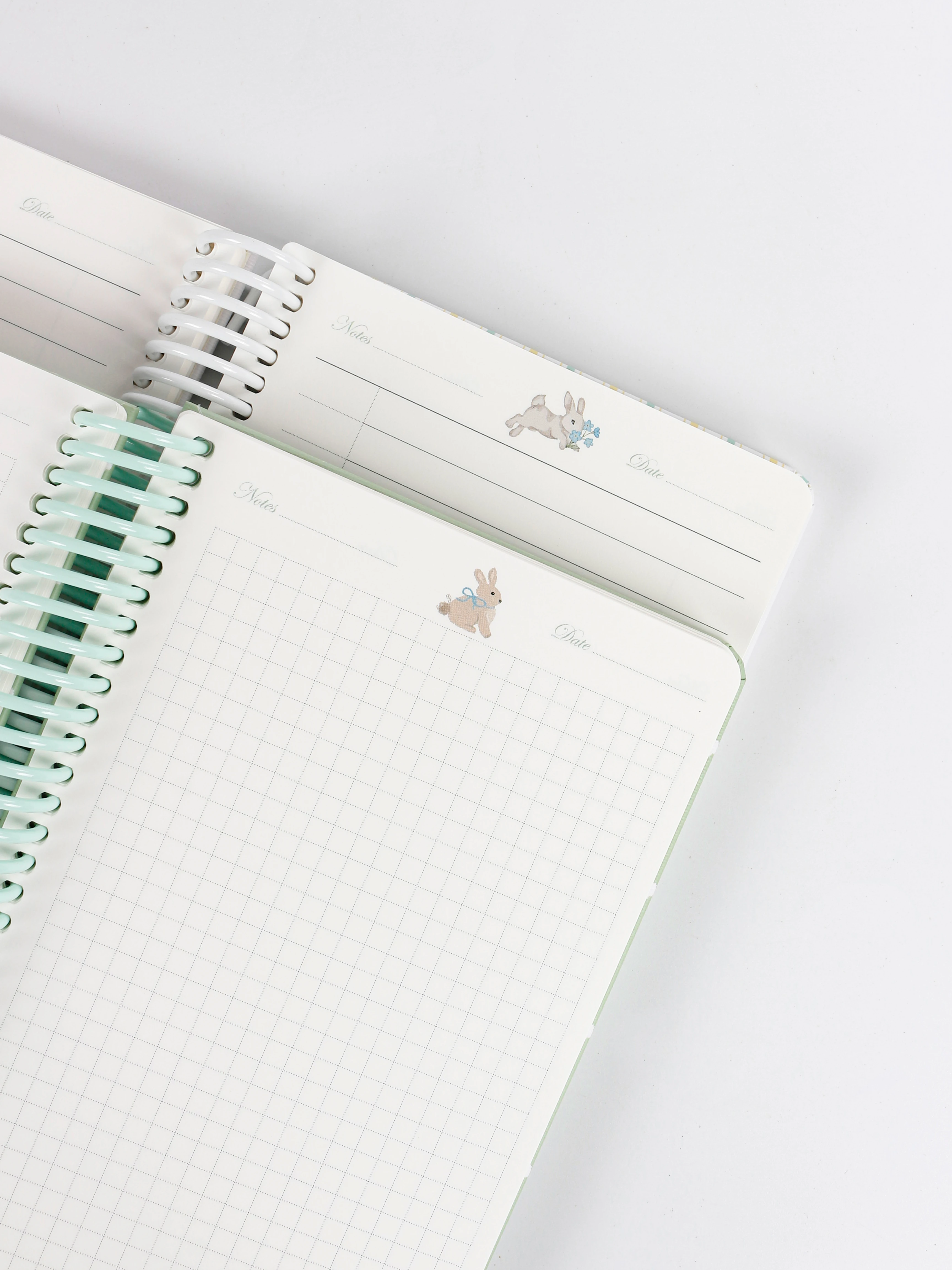 Custom spiral notebook inner pages: printed lined and grid pages on fountain-pen-friendly paper with colour-matched plastic coils Custom spiral notebook inner pages: printed lined and grid pages on fountain-pen-friendly paper with colour-matched plastic coils